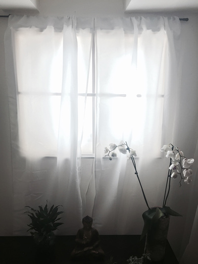 A realistic-looking fake window covered in curtains